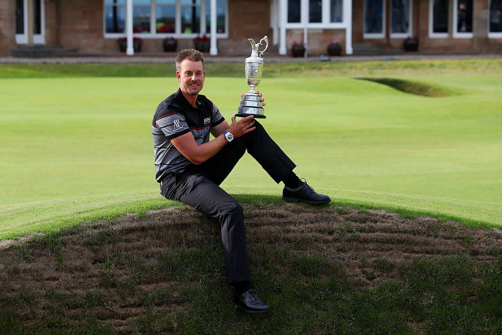 Henrik Stenson celebrates victory as he poses with the Claret Jug on the the 18th green after the final round on day four of the 145th Open Championship at Royal Troon